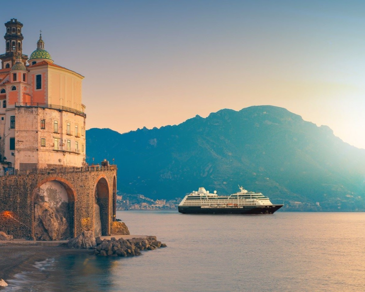 cruise ship sailing at sunrise