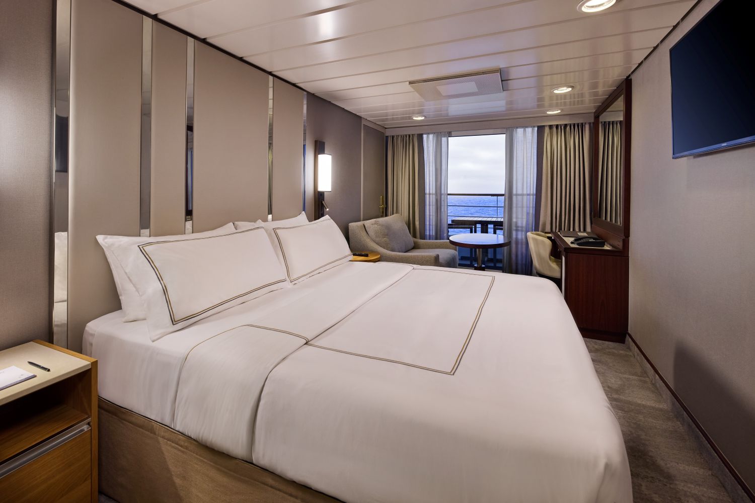 Veranda Stateroom with bed, sofa seating, desk, and private veranda.